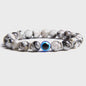 Set van 2 Handgemaakte Natuursteen Armbanden met Hanger Oog van Fatima & Lavasteen/Hematiet