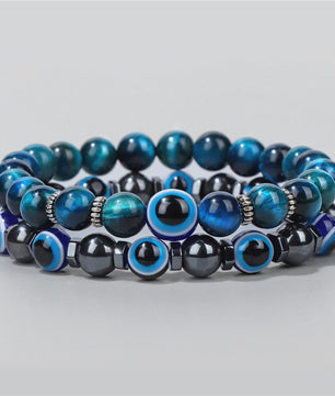 Set van 2 Handgemaakte Natuursteen Armbanden met Hanger Oog van Fatima & Lavasteen/Hematiet