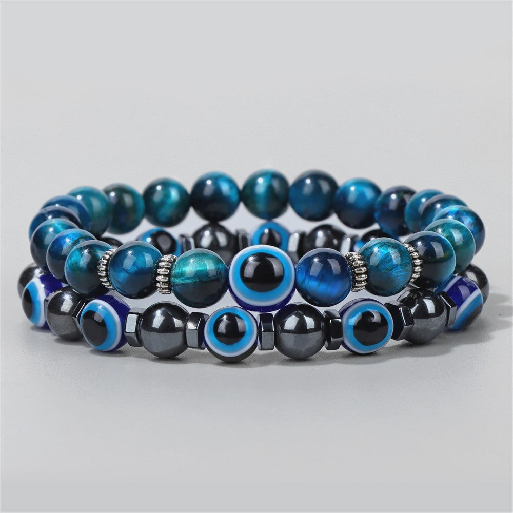 Set van 2 Handgemaakte Natuursteen Armbanden met Hanger Oog van Fatima & Lavasteen/Hematiet